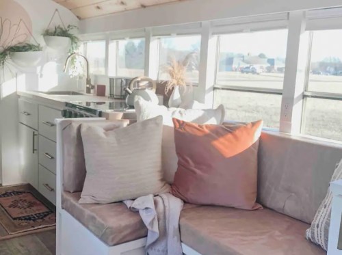 Cozy interior of a bright, modern kitchen with a comfortable seating area and large windows.