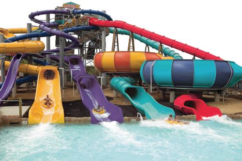 Colorful water slides at a water park, with riders splashing into a pool below.