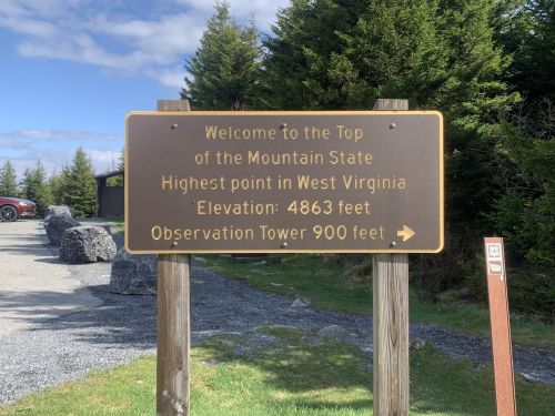 Sign welcoming visitors to the highest point in West Virginia, with elevation and observation tower details.