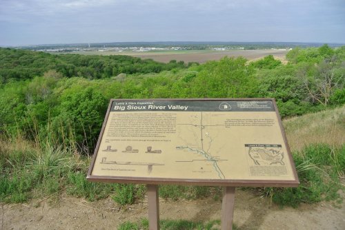 A sign detailing the Big Sioux River Valley, surrounded by greenery and overlooking a vast landscape.