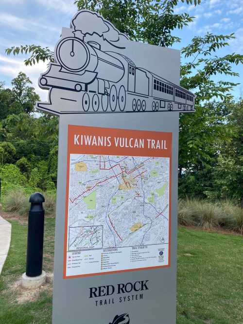 Sign for Kiwanis Vulcan Trail featuring a train graphic and a map of the Red Rock Trail System.