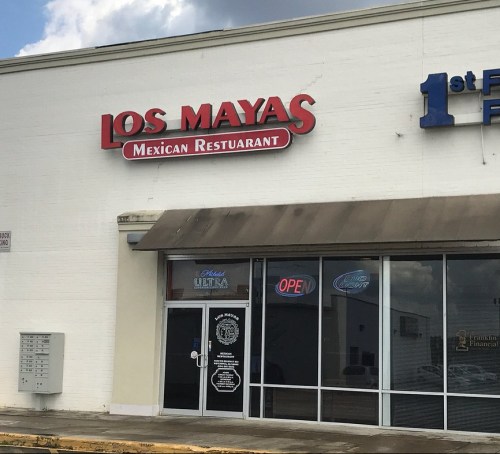 Sign for "Los Mayas Mexican Restaurant" with an open sign in the window, located in a commercial building.