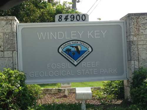 Sign for Windley Key Fossil Reef Geological State Park, featuring the Florida Park Service logo and the park's address.