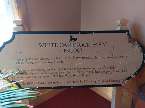 Sign for White Oak Stock Farm, established in 1898, detailing its history and notable guests.