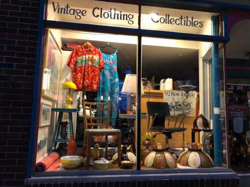 A vintage shop window displays colorful clothing, collectibles, and decor items, creating a nostalgic atmosphere.