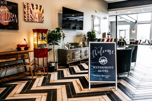 A welcoming interior of the Waterfront Hotel featuring a sign, popcorn machine, and stylish flooring.