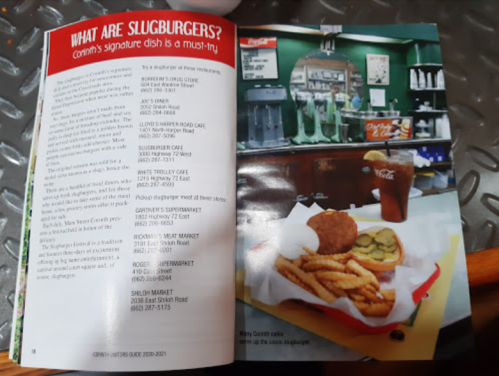 Image of a menu page featuring slugburgers, fries, pickles, and a drink in a diner setting.