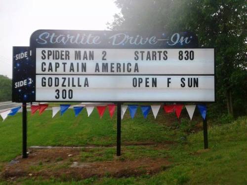 Sign for Starlite Drive-In featuring movie showtimes: "Spider Man 2" at 8:30, "Captain America," and "Godzilla" at 3:00.