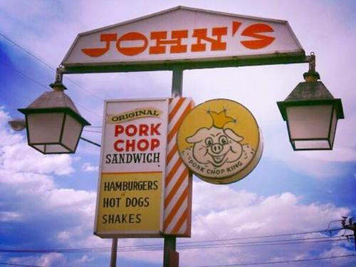Sign for John's featuring "Original Pork Chop Sandwich," with options for hamburgers, hot dogs, and shakes.