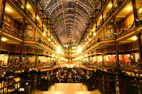 A beautifully lit, ornate indoor space with festive decorations, showcasing a grand architectural design.