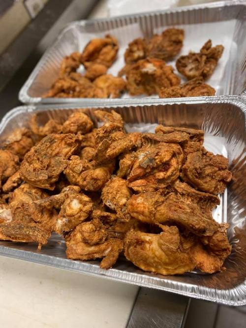 Two trays filled with crispy, golden-brown fried chicken pieces.