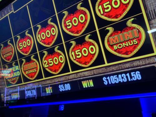 A slot machine display showing various jackpot amounts, with a total win of $105,431.56 and a bet of $5.00.