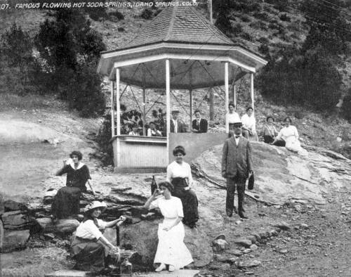 A vintage photo of people gathered around a gazebo in Soda Springs, Idaho, enjoying the natural hot springs.