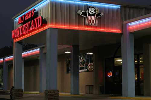 Exterior of Billy Bob's Wonderland, featuring neon lights and a playful bear mascot sign.