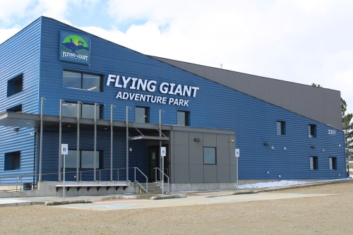 Exterior of the Flying Giant Adventure Park building, featuring a blue facade and large signage.