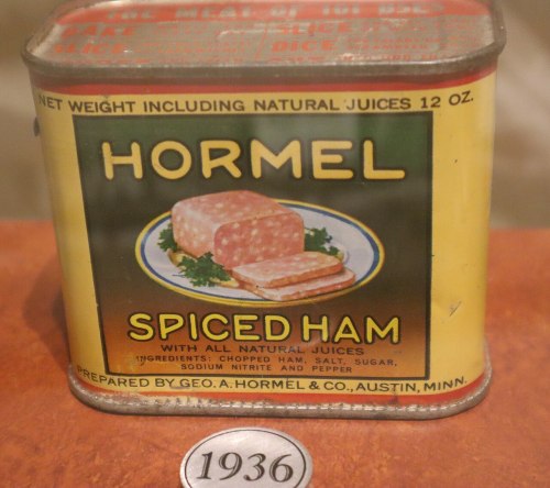 Vintage Hormel Spiced Ham can from 1936, featuring a colorful label and a depiction of sliced ham on a plate.
