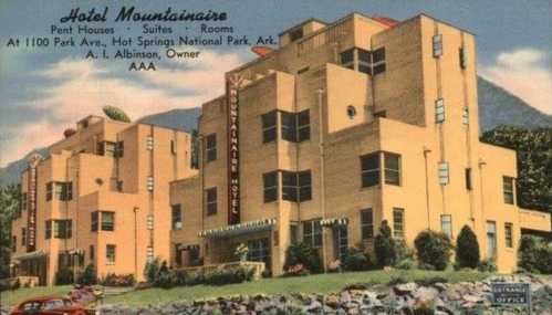 Vintage postcard of Hotel Mountainaire, a yellow building with multiple stories, located in Hot Springs National Park, Arkansas.