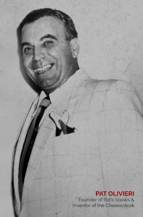 Black and white photo of a smiling man in a suit, identified as Pat Olivieri, founder of Pat's Steaks and cheesesteak inventor.