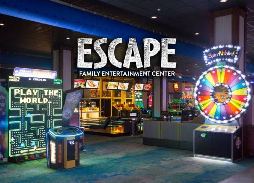 Bright arcade with various games and a colorful prize wheel, featuring the text "ESCAPE FAMILY ENTERTAINMENT CENTER."