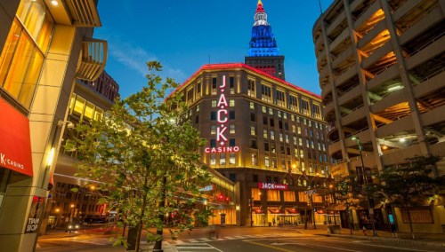 A brightly lit casino building at dusk, featuring "JACK CASINO" signage and a colorful illuminated tower.