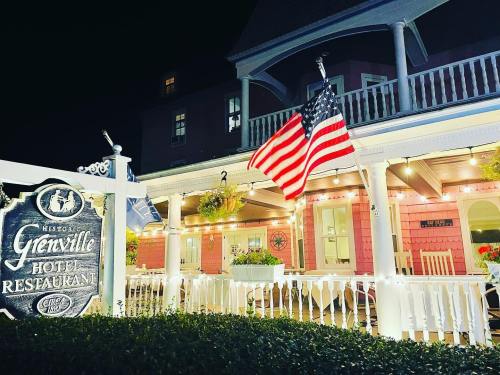 Historic hotel and restaurant at night, featuring American flags and decorative lights on the porch.