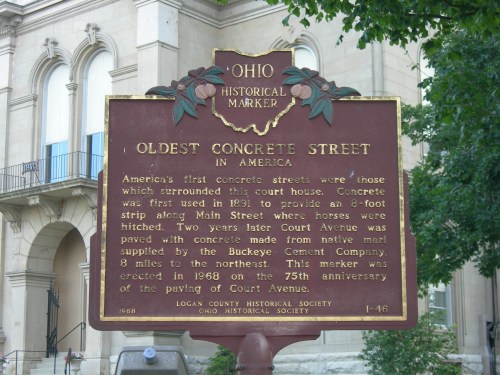 Historical marker about the oldest concrete street in America, located near a courthouse in Ohio.