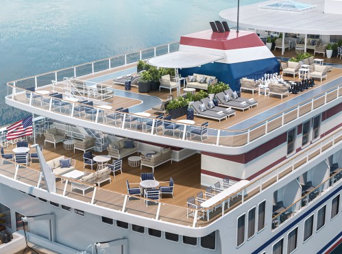 Aerial view of a cruise ship deck featuring lounge chairs, plants, and a pool area, with water in the background.