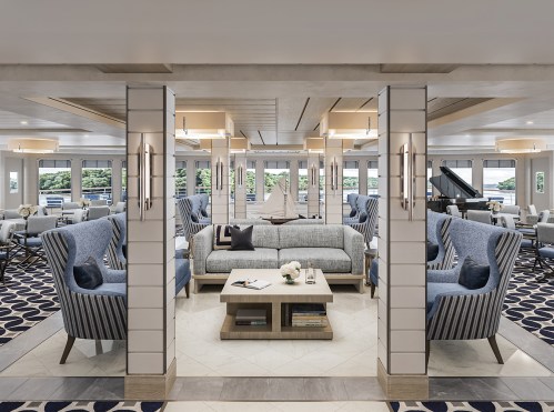 A modern lounge area with blue armchairs, a gray sofa, and elegant decor, featuring large windows and a piano.