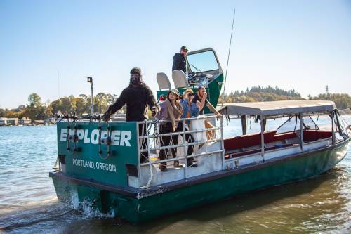 A boat named "Explorer" in Portland, Oregon, with people preparing for a trip on the water.