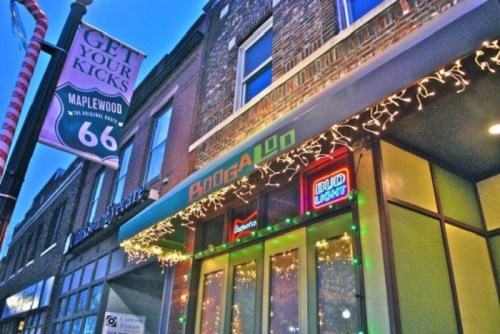 A storefront with festive lights, featuring a sign that reads "BooGaloO" and a neon "Bud Light" sign.