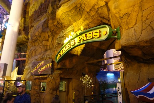 Entrance to "Pirate's Pass" featuring a rocky, cave-like structure with colorful signage.