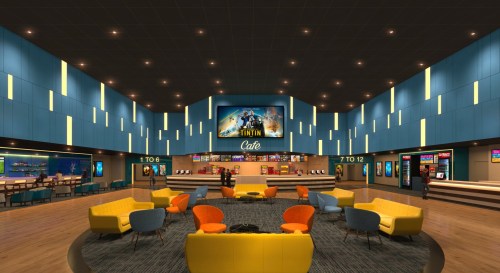 A modern cafe with colorful seating, bright walls, and a large screen displaying "Tintin Cafe" in a lively atmosphere.