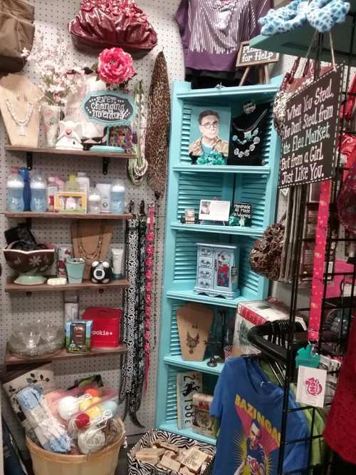 A colorful display of various handmade items, accessories, and decor in a boutique setting.