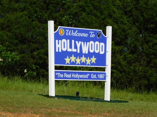 Welcome sign for Hollywood, featuring five stars and the text "The Real Hollywood" established in 1887.