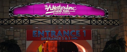 Sign for The Adventuredome Theme Park, featuring "Circus Circus" and marked entrances. Bright colors and playful design.