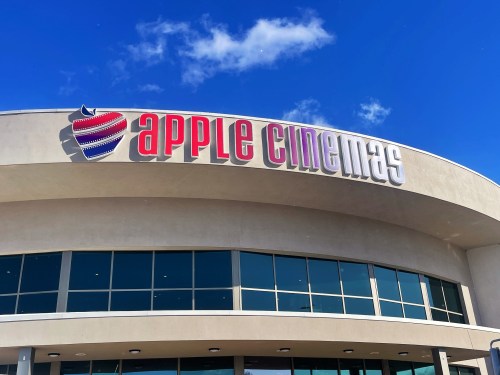 Exterior of Apple Cinemas building with a blue sky and clouds in the background.