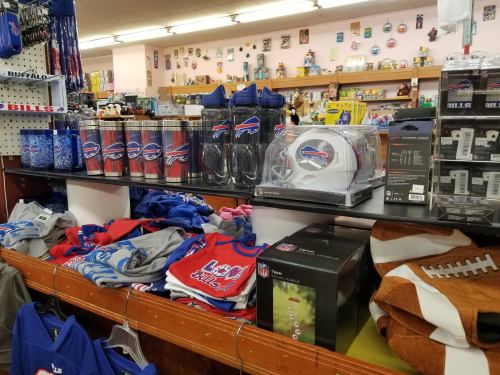 A display of Buffalo Bills merchandise, including mugs, apparel, and football-themed items in a store.
