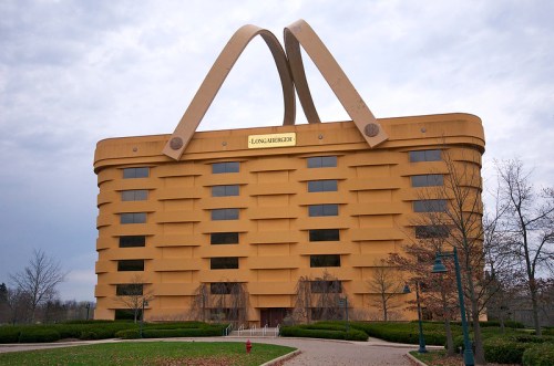 A large, yellow building shaped like a basket, featuring a handle and the sign "Longaberger" on the front.