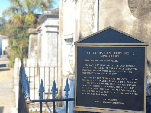 Sign at St. Louis Cemetery No. 1 in New Orleans, detailing its history and significance as a burial place.