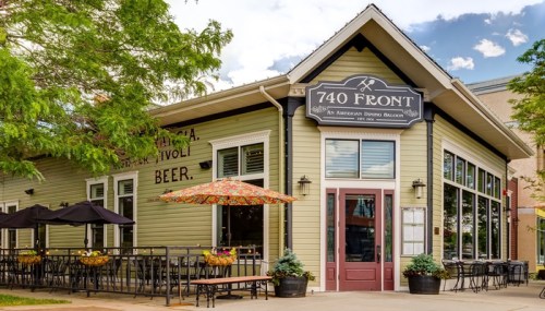 Exterior of 740 Front, a restaurant with outdoor seating, colorful umbrellas, and a welcoming entrance.