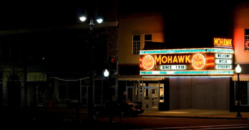 The illuminated Mohawk theater marquee at night, featuring "Welcome MCLA Students" and "Since 1938."