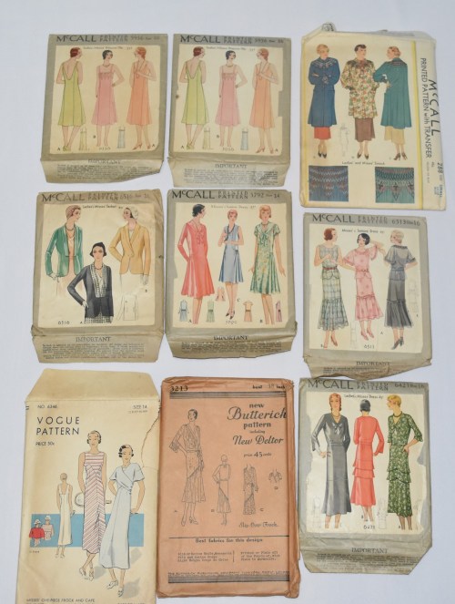 A collection of vintage sewing patterns from McCall, Vogue, and Butterick, featuring various dress designs.