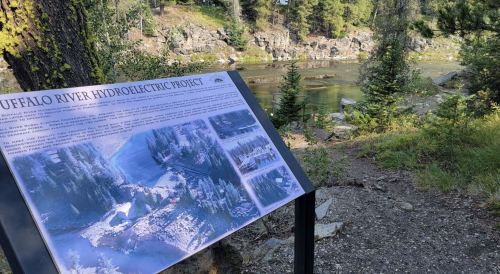 Sign about the Buffalo River Hydroelectric Project, with a scenic river and trees in the background.