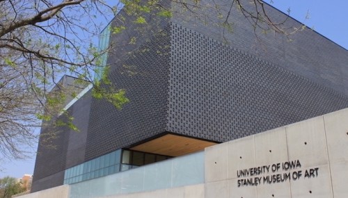 Modern building of the University of Iowa Stanley Museum of Art, featuring a sleek black facade and large windows.