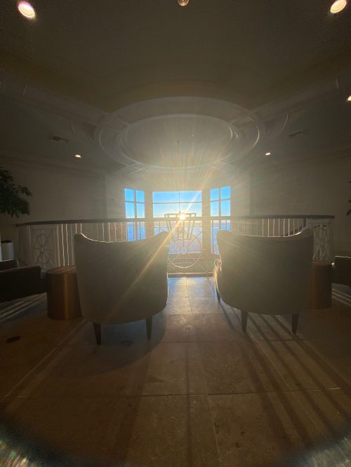 Two chairs facing a bright window, with sunlight streaming in, creating a warm and inviting atmosphere.