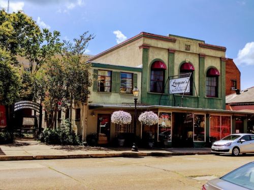 A colorful restaurant building with large windows, hanging flower baskets, and a sign reading "Fay's Restaurant."