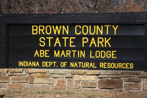 Sign for Brown County State Park and Abe Martin Lodge, featuring yellow text on a black background.