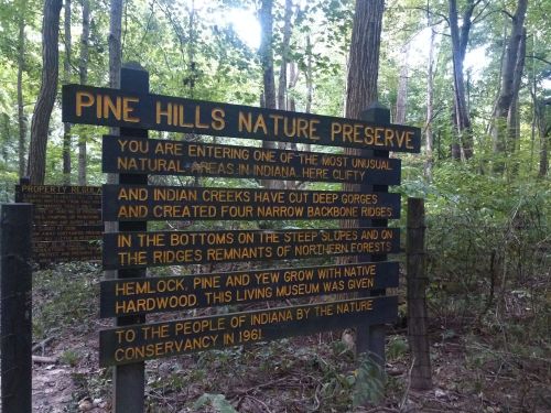 Sign at Pine Hills Nature Preserve, Indiana, detailing the area's unique natural features and history.