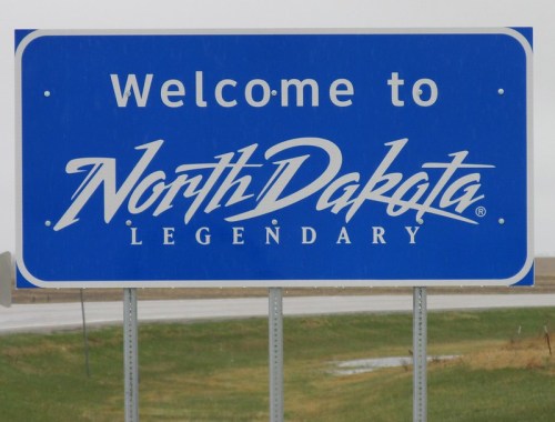 Welcome sign for North Dakota, featuring the word "Legendary" in stylized lettering.