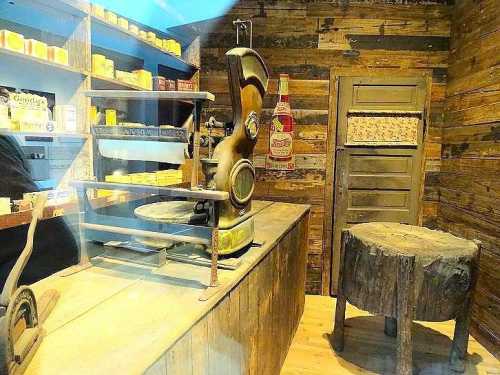 Vintage store interior featuring an old-fashioned scale, wooden shelves with products, and a rustic wooden table.